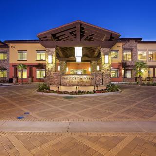 A modern building with illuminated lights at night, featuring an open courtyard.