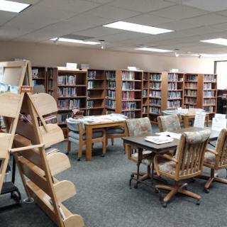 A cozy library featuring rows of bookshelves and a comfortable reading area.