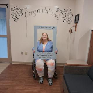 A joyous moment captured as someone celebrates a significant achievement in a wheelchair.