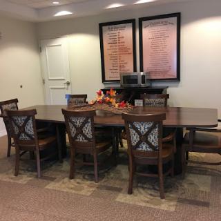 A well-furnished conference room with a large table and comfortable chairs.