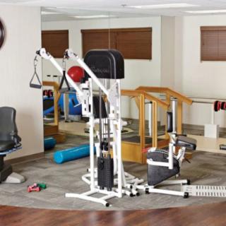 A well-equipped home gym with a versatile exercise machine and other fitness accessories.