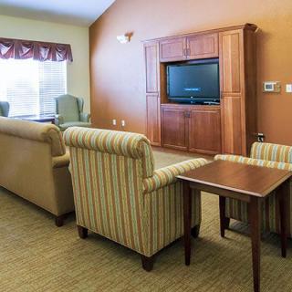 A cozy living room with comfortable seating and a large TV.