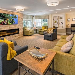 A modern living room with comfortable seating, a fireplace, and a large television.