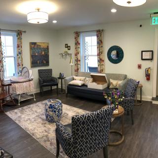 A cozy living room with a variety of seating options and decorative elements.