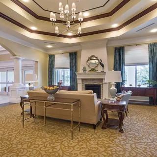 Elegant living room with a chandelier and fireplace.