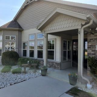 A well-maintained residential building with a landscaped entrance and large windows.