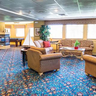 A cozy living room with comfortable seating, a coffee table, and bright decor.