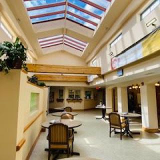 A well-lit interior dining area with skylights and modern furniture.