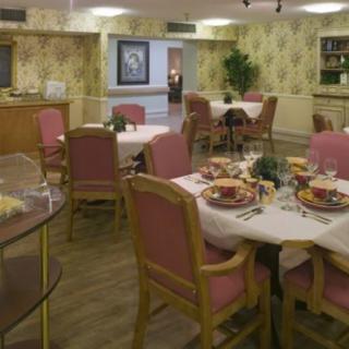 A cozy dining room with elegantly set tables and comfortable seating.