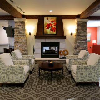 A cozy living room with a fireplace and comfortable seating arrangement.