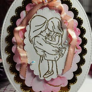 A charming handmade card featuring an illustration of two children sharing a sweet moment.