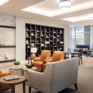 A modern lounge area with stylish furniture and shelves.