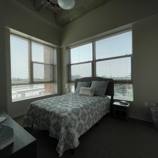 A modern bedroom with large windows allowing ample natural light.