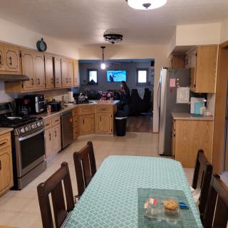 A cozy kitchen and dining area with wood cabinetry and a dining table.