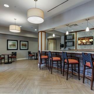 A modern bar area with comfortable seating and stylish lighting.