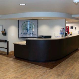 A modern reception desk in an office lobby setting.
