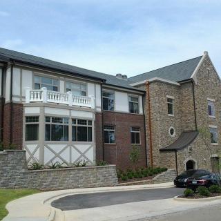 A modern residential building with a combination of stone and brick exterior.