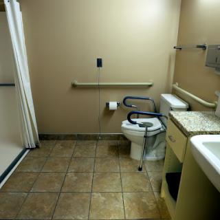 A spacious and accessible bathroom featuring essential amenities.
