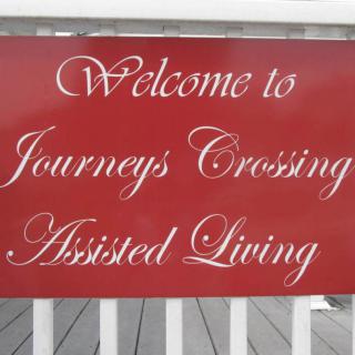A welcome sign for Journeys Crossing Assisted Living.