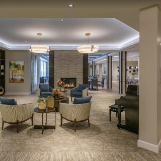 A modern lobby with comfortable seating and a fireplace.