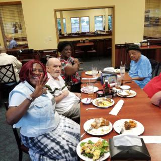 A group of friends enjoying a meal together at a restaurant.