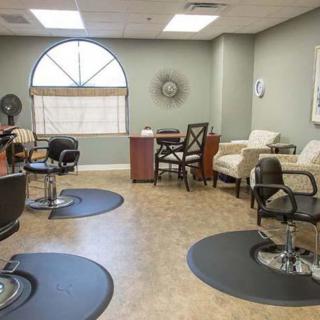 An interior view of a hair salon with styling chairs and a waiting area.