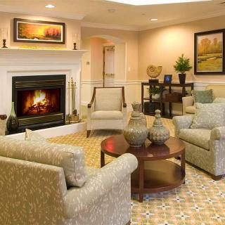 A cozy living room featuring comfortable seating and a warm fireplace.