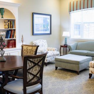 A cozy living room with a sofa, armchairs, and a coffee table.
