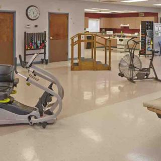 A physical therapy room equipped with various exercise machines and facilities.