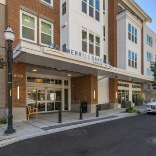 A modern hotel entrance with large windows and a clean, inviting facade.