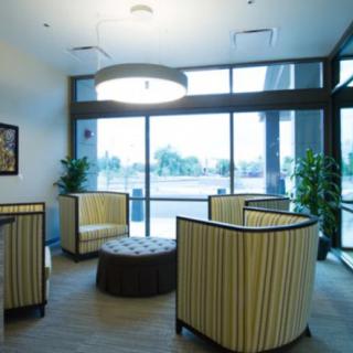 A modern waiting area with comfortable seating and large windows.
