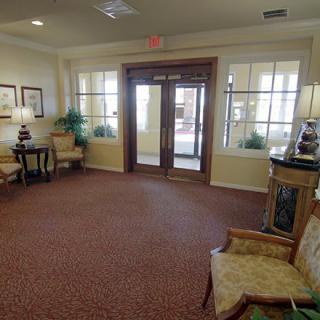 A cozy and well-furnished lobby with seating arrangements and decorative elements.