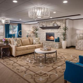 A luxurious living room with elegant furnishings and a cozy fireplace.