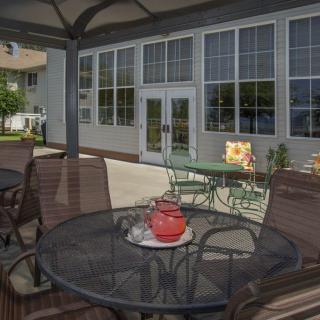 A cozy outdoor patio with seating and decor, perfect for relaxation.