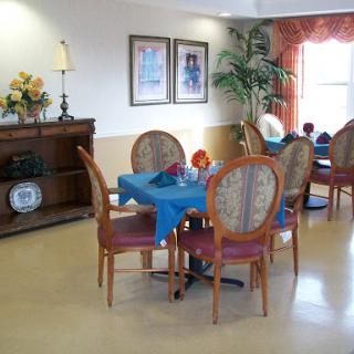 A cozy dining area featuring wooden furniture with a simple and inviting decor.
