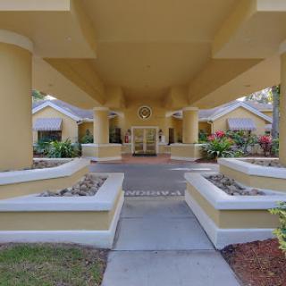 The welcoming entrance of a modern building surrounded by vibrant landscaping.