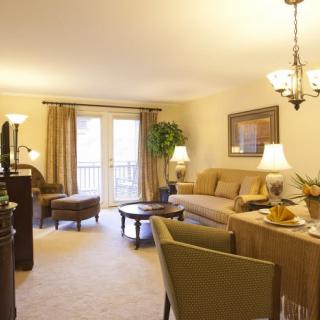 A cozy and elegantly decorated living room with a comfortable sofa, warm lighting, and stylish furnishings.