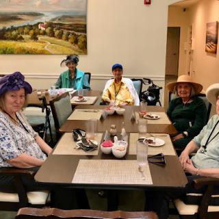 A lively group of senior citizens enjoying a meal together, showcasing camaraderie and community.