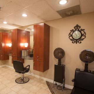 A cozy hair salon featuring stylish barber chairs, mirrors, and ambient lighting.