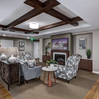 A modern and cozy living room with a fireplace and stylish furnishings.