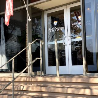 Entrance of a building with stairs and glass doors.