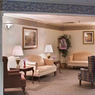 A cozy living room with sofas, lamps, and decorative elements.