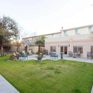 A spacious backyard with a well-maintained lawn and outdoor seating area.