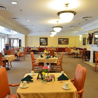 An elegant dining room with neatly arranged tables and chairs.