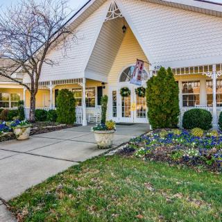 A residential building with landscaped gardens and a welcoming entrance.
