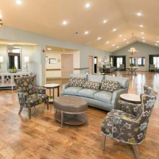 A spacious living room with stylish furniture and elegant lighting.