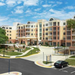 A modern residential apartment complex with well-maintained landscaping.