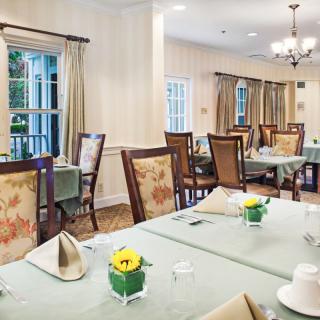 An elegant dining room with neatly arranged tables and chairs.