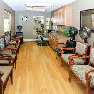 A spacious waiting room with multiple chairs arranged along the walls.