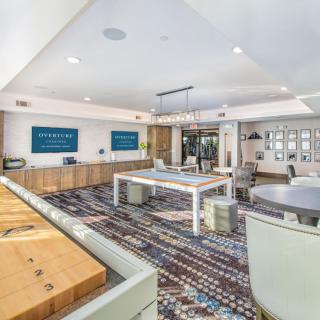 A modern office space with an open floor plan, featuring contemporary furniture and decorative elements.